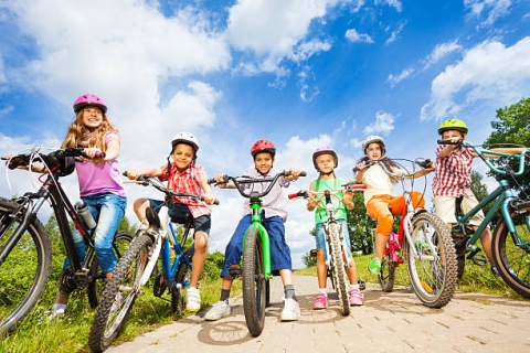 Kids on bikes with helmets.